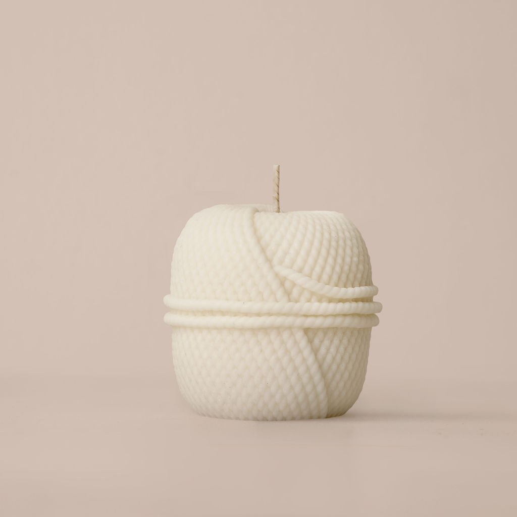 Sculptural candle inspired by woven Nordic forms, model 019, hand-poured in natural wax.